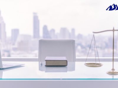 Justice Scale, Laptop, Book on a Table- Experienced Rape Criminal Defense Attorney