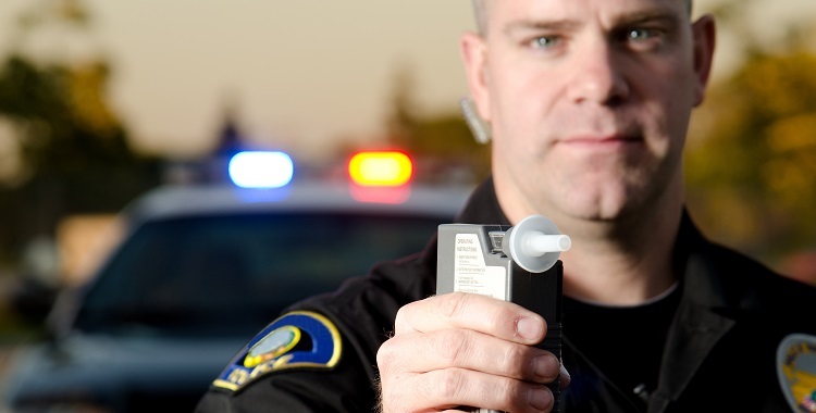 Officer giving a Breathalyzer test - DWI vs DUI in Utah
