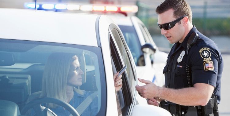 Woman Presenting her ID to a Police Officer - Driving on a Suspended or Revoked License Defense Lawyer in Salt Lake City