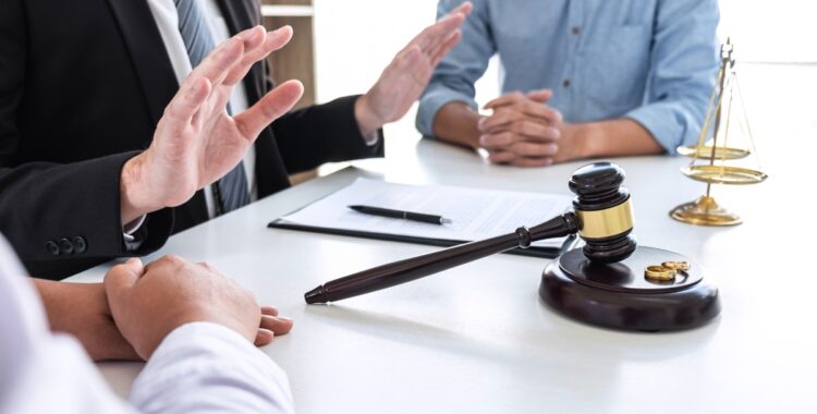 man consulting with defense attorney about serious charges