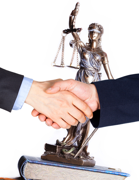 Shaking Hands in front of the Scales of Justice