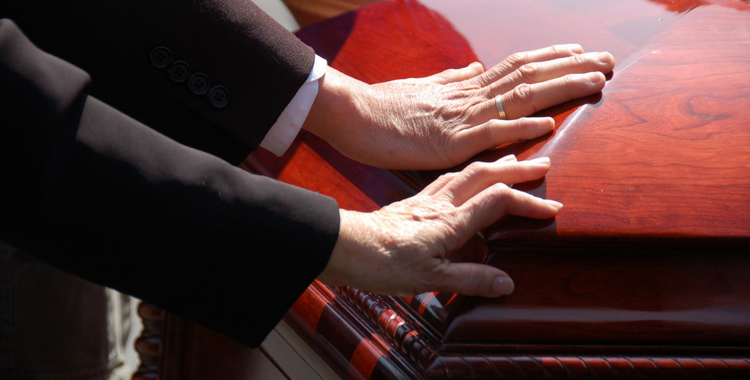 Hands on a casket - Wrongfull Death Lawyer